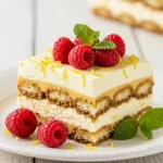 Best lemon raspberry tiramisu with fresh raspberries and mint on a white plate